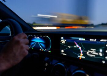 person's hand on steering wheel